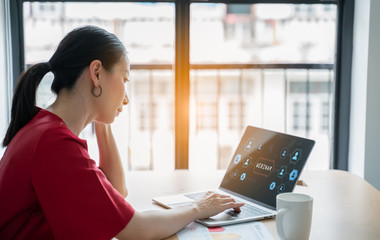 Businesswoman watching labtop webinar video course at home office.Happy woman student listening...