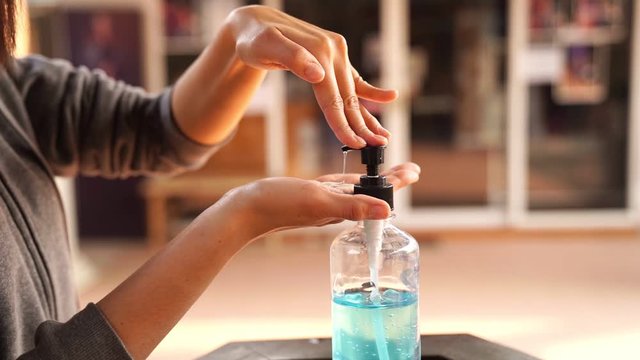 Woman hand using alcohol wash gel for cleaning  dispenser health care concept