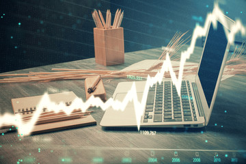 Financial graph colorful drawing and table with computer on background. Multi exposure. Concept of...