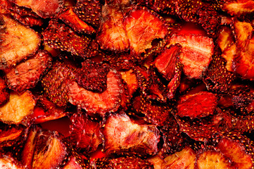 Chips from dried strawberries, sliced into thin slices. Background for healthy eating and vegetarianism. Snacks