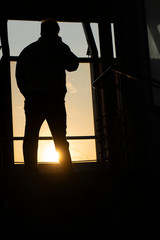 Silhouette of a man who is talking on the phone