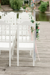 decorated chairs on wedding ceremony