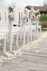 decorated chairs on wedding ceremony
