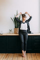 Adult serious girl woman businesswoman freelancer in a business suit working at home, sitting on a chair and thinking about work ideas, work at home, break, stress, modern office, workplace