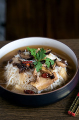 Fusion asian noodle soup with mushrooms in bowl