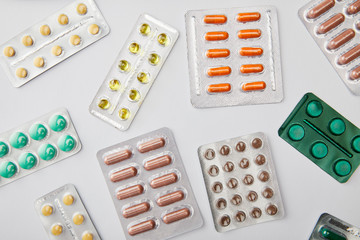 Top view of different pills on white background