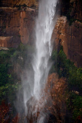 Fototapeta na wymiar Powerful waterfall tumbling over sandstone cliffs