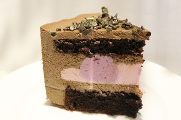 A piece of cheesecake with a pink berry layer is very appetizing and tasty.