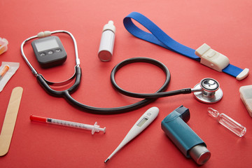 High Angle View of medical objects on red background