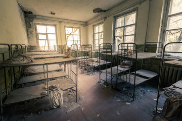 Room with broken bunk beds in abandoned kindergarden in Chernobyl Exclusion Zone