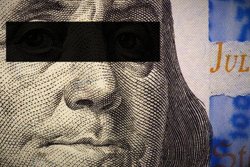 Franklin's face close-up with a black stripe of censorship on his eyes on a fragment of a 100...
