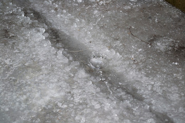 weather changes drops from icicles dripping into snow.