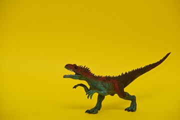 colored dinosaur toy two-legged predator