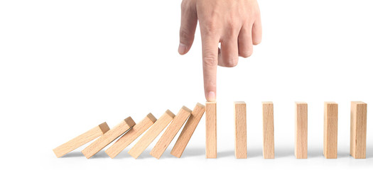 Hand stopping the Domino effect stopped by unique