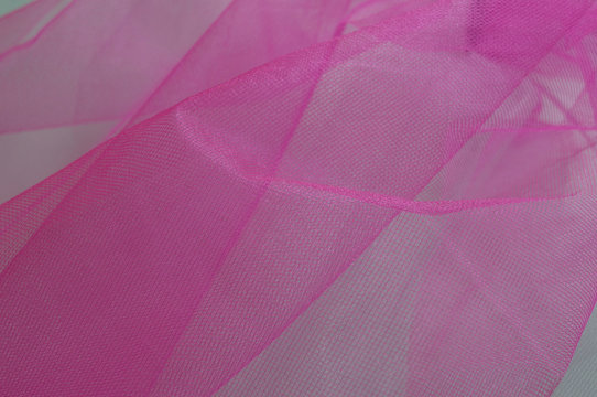Bright white and pink banground of transparent material with tiny holes