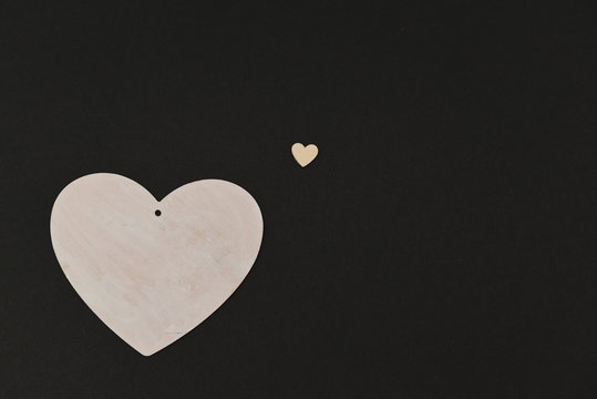a large white heart made of wood and a small copy of it