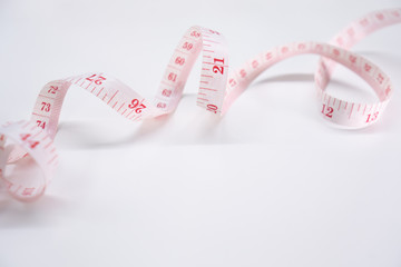 Measure tape on white background. Concept for diet  weight lose and measurement.