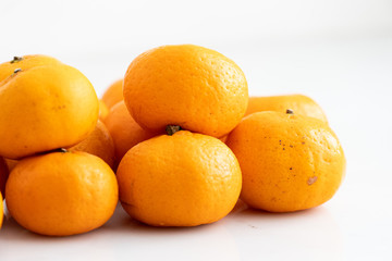 multiple orange on  white marble surface. Concept for fruit nutrition and diet food.