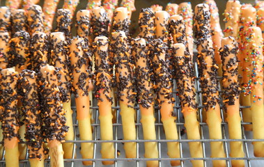 Striped wafer rolls filled with chocolate isolated on white