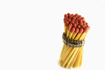 Matches were tied in a metal ring isolated on white background.
