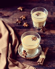Masala tea in glass glasses on a dark wooden background. rustic  