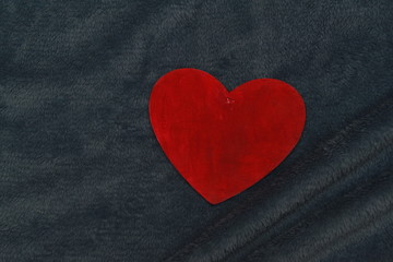 Obraz premium big red heart on a warm blanket