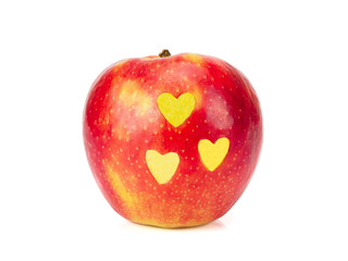 Fresh red apple with yellow hearts on its side isolated on white background