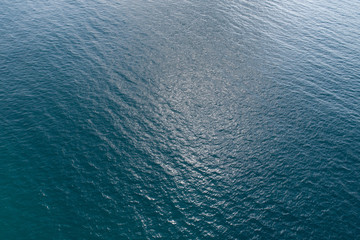 Drone aerial view of sea wave surface in the sunrise