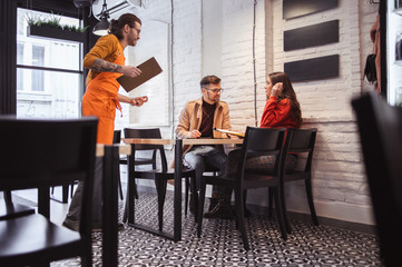 Waiter Takes Order From a young Couple