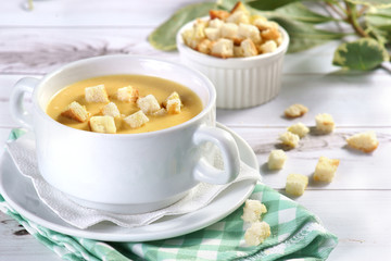 cream cheese soup with crackers on a light background
