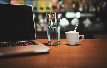cup of coffee and laptop on table. 