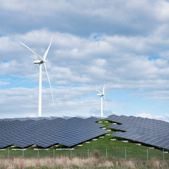 wind turbines and solar panels form alternative enery plant close together