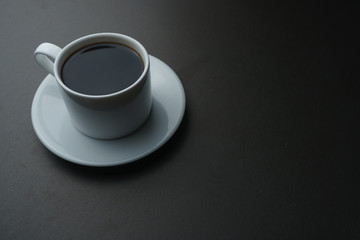 coffee cup on black office desk. fine art. copy space for your text