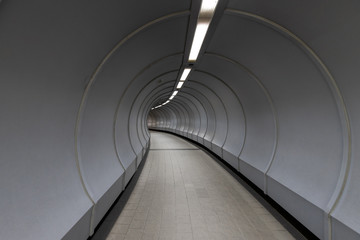 Obraz premium Curved walkway inside pedestrian crossing tunnel.