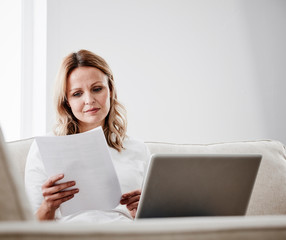 Mature woman at home checking her bills