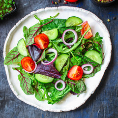Healthy salad, leaves mix salad (mix micro greens, cucumber, tomato, onion, other ingredients). keto or paleo diet top concept, food background copy space for text