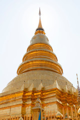 Fototapeta premium Beautiful Golden Pagoda in a Temple in Northern Thailand. Golden Pagoda background at the beautiful temple.