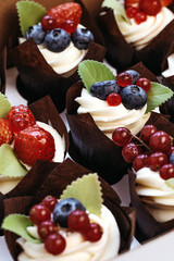 Bright cupcakes with strawberries and blueberries.
