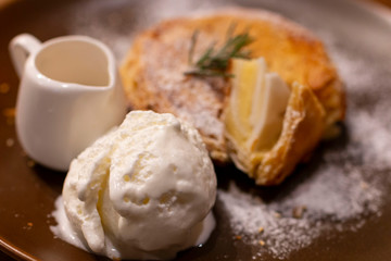 Ice Cream with coconut pie on a rustic plate with syrup. Homemade Vanilla Ice cream together with fresh make coconut pie. Selective focus of Ice Cream serve with Homemade coconut pie.