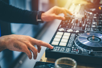 DJ pushing button on the turntable.