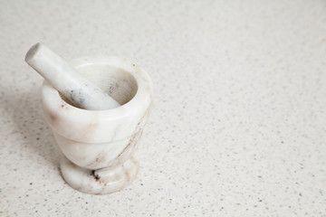 Granite white mortar and pestle with selective focus and copy space