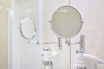 Bathroom interior, close-up make-up mirror and hairdryer