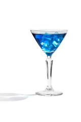 Blue Lagoon cocktail with ice cubes is contained in a martini glass. The showy illustrative picture is made on the white background.