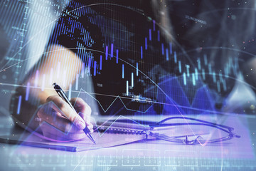 Multi exposure of woman's hands making notes with forex graph hologram. Concept of technical analysis.