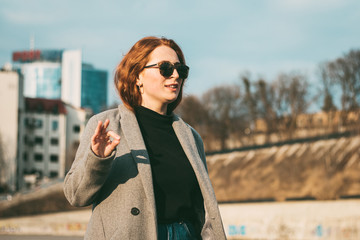 A beautiful red-haired woman smiles and talking.
