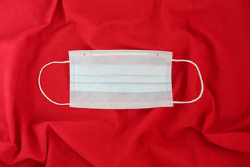 Face mask with text on red background. Stop coronavirus concept.