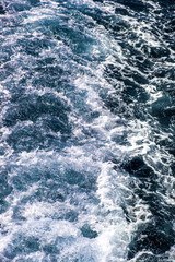 Fototapeta na wymiar Top down aerial view of sea water surface. White foam waves texture as natural background.
