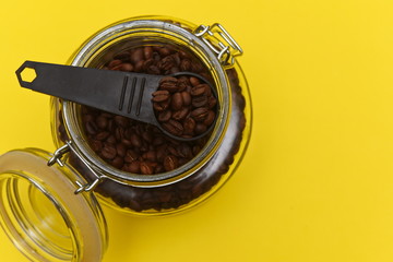 measuring spoon in an open glass coffee jar