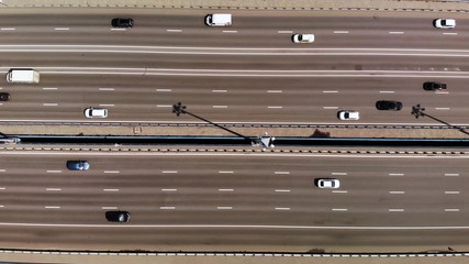 Top down aerial view on 11 lanes bridge with lot of cars and buses. moving right