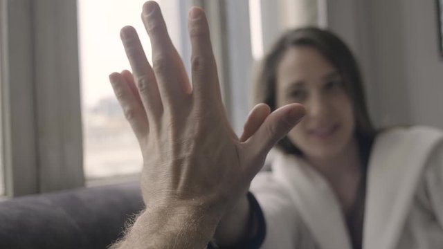 couple touching hands comparing hand size. pov close up